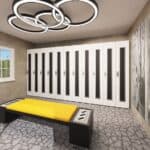 Modern locker room with a row of tall white lockers, a black bench with a bright yellow cushion, and circular ceiling lights.