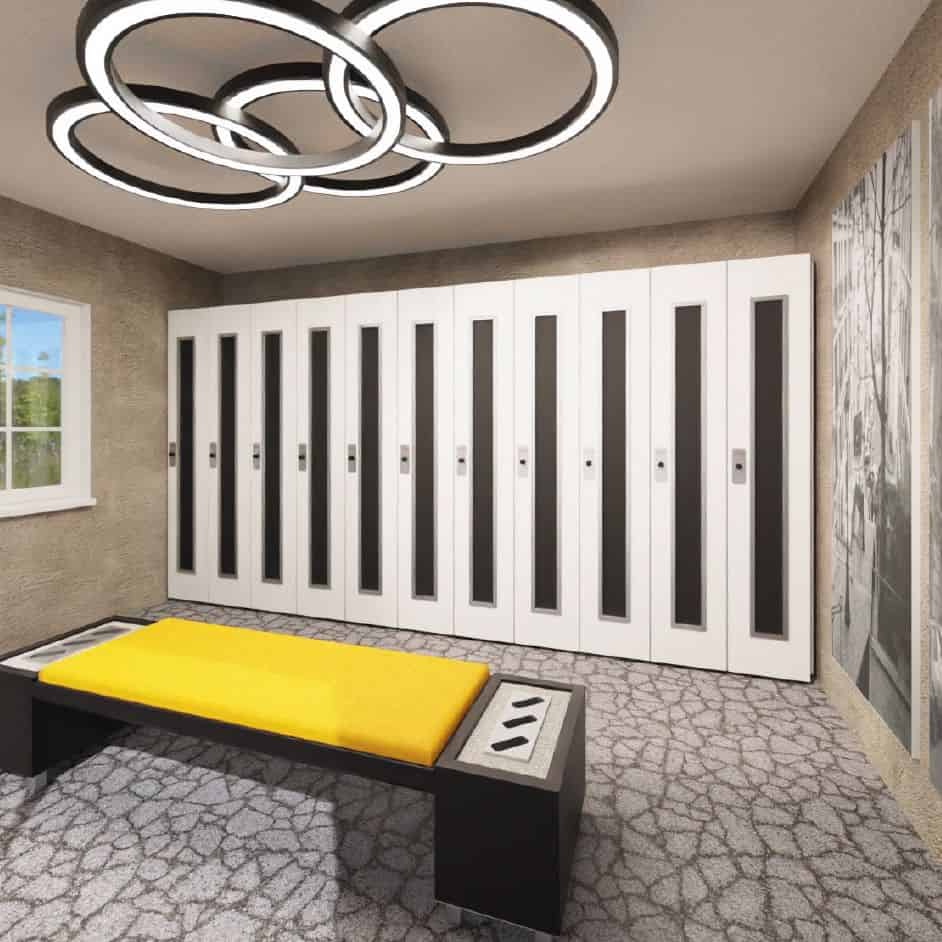 Locker room with white lockers, a yellow bench cushion, and circular ceiling lights.
